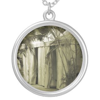 white tents behind palm fronds sepia pendants