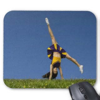 Female cheerleader doing cartwheel mouse pads