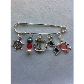 Divine Beads Nautical Themed Brooch, Ready to wear. Contains 5 themed charms Ships Rudder, Nautical Colours Bead Charm, Anchor Charm, Sunglasses and Rhinestone Crab CharmBr. Easily attached you can mix and match with our entire collection. All purchases f