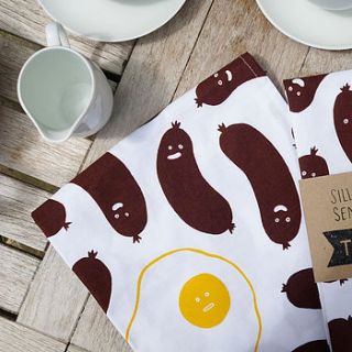 silly sausages sensible egg tea towel by stormy knight