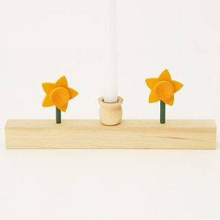 small wooden candle holder with daffodils by drift living