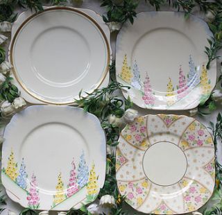 four mismatched vintage plates by the vintage tea cup