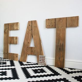 giant handmade reclaimed wooden 'eat' sign by ruby rhino