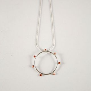 silver and copper circular seed pendant by angela evans jewellery