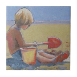 Little boy playing in the sand with a shovel ceramic tiles