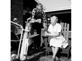 Mid adult man and mother having break from playing golf Poster Print (18 x 24)